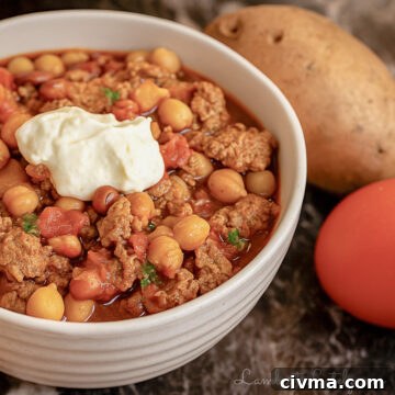 turkey chili in a bowl, topped with sour cream.
