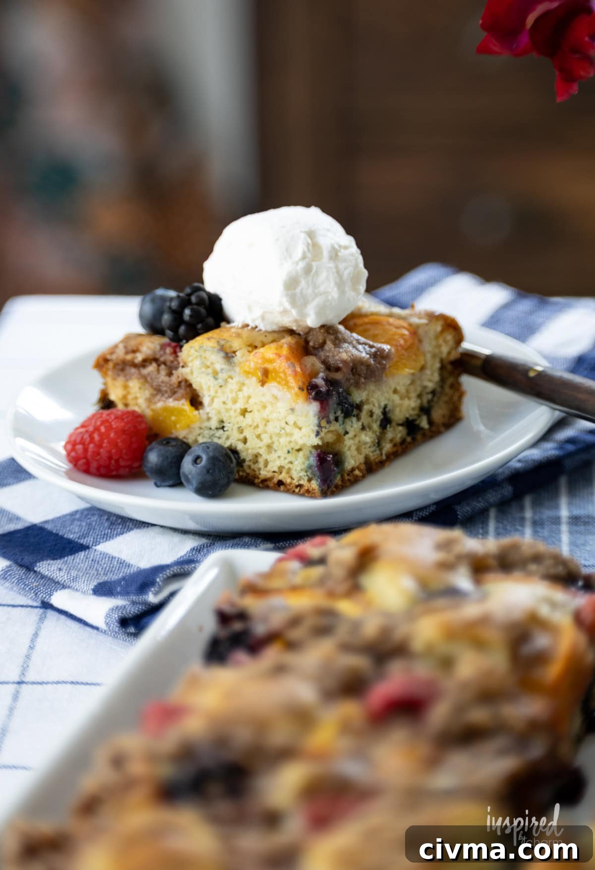 slice of Nectarine and Berry Buckle on a plate with a fork.
