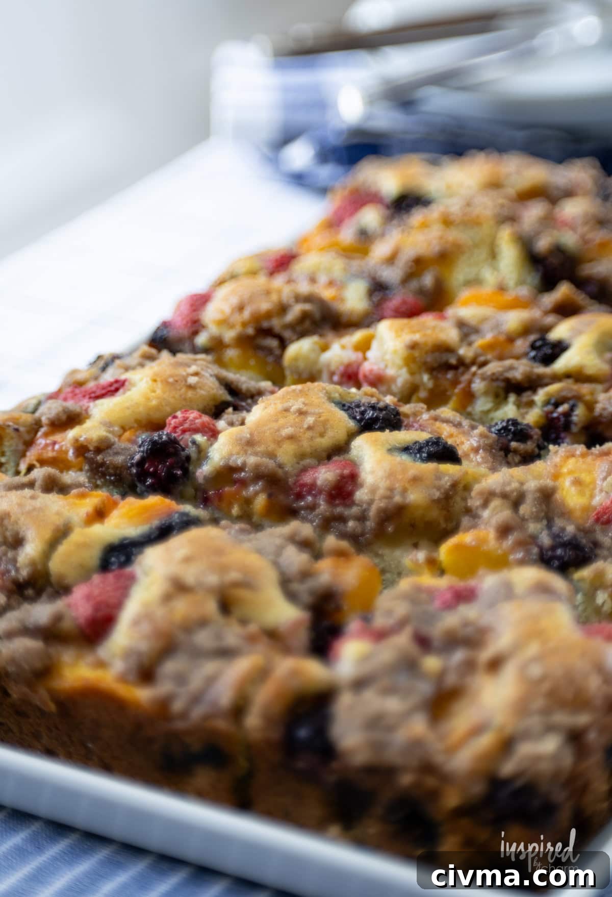 large white plate filled with pieces of Nectarine and Berry Buckle.