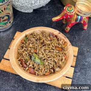 Traditional sesame rice dish served in a wooden bowl with decorative elephant figurine.
