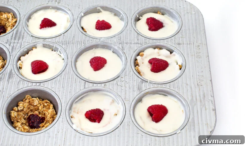Assembling the white chocolate oat cups in a muffin tin.