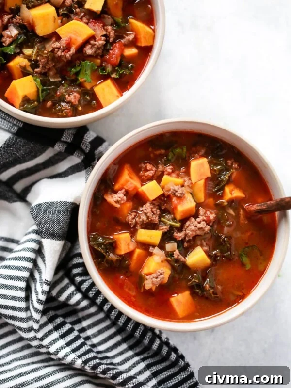 overhead view of two bowls containing Ground Beef Butternut Squash Kale Soup