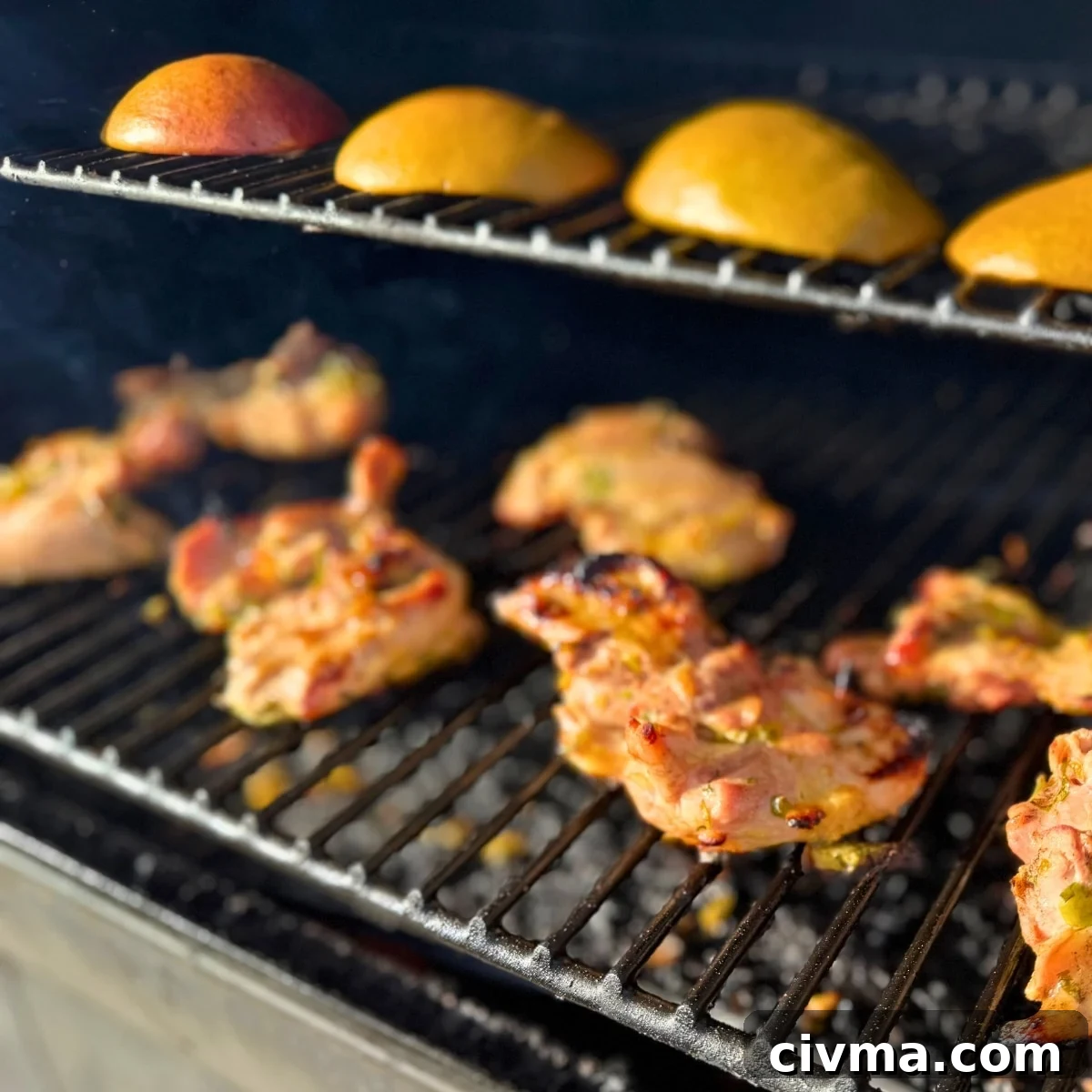 grilling chicken thighs on grill with mangoes