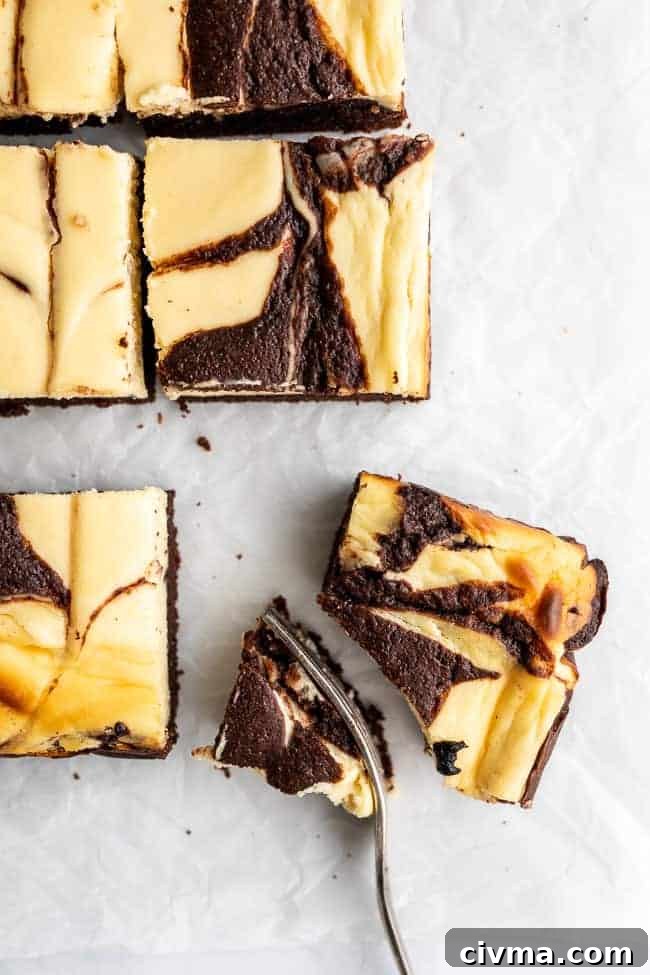Keto Cheesecake Brownies Recipe 6 cheesecake brownie with a fork slicing a quarter out.