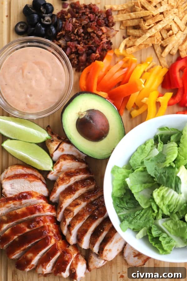 Grilled chicken salad recipe with topping ideas laid out on a cutting board. bbq salad recipe, grilled chicken salad recipes. bbq salad.