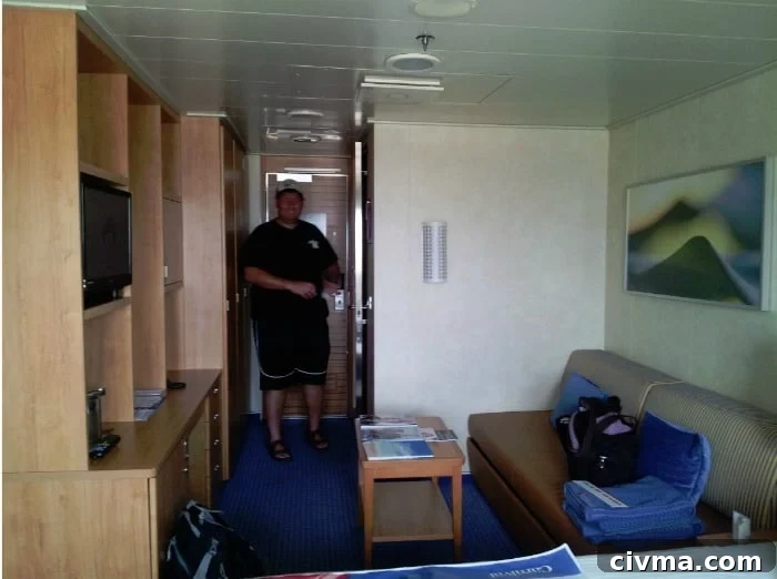 John standing near the door in the carnival breeze stateroom 