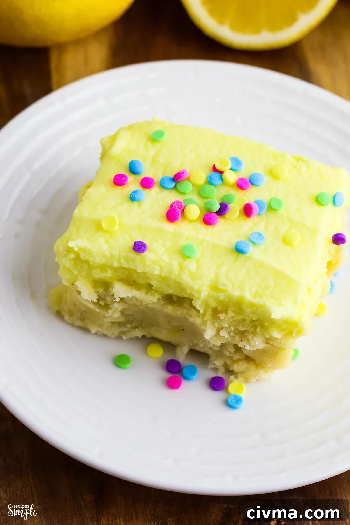 Lemon Cookie Bars with Zesty Lemon Buttercream 2 Lemon Cookie Bars topped with sprinkles on white plate
