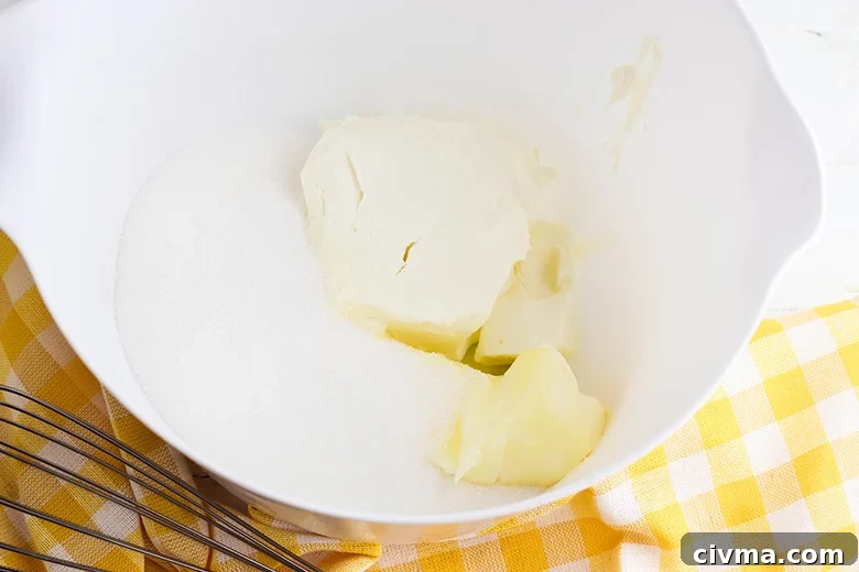 Lemon Cookie Bars with Zesty Lemon Buttercream 5 butter cream cheese and sugar in bowl