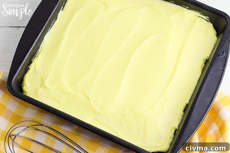 Lemon Cookie Bars with Zesty Lemon Buttercream 6 Frosted Lemon Cookie Bars in baking pan
