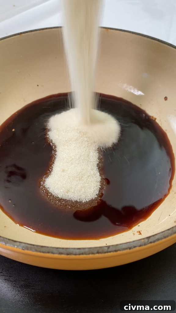 Tofu cooking in soy sauce and sugar glaze