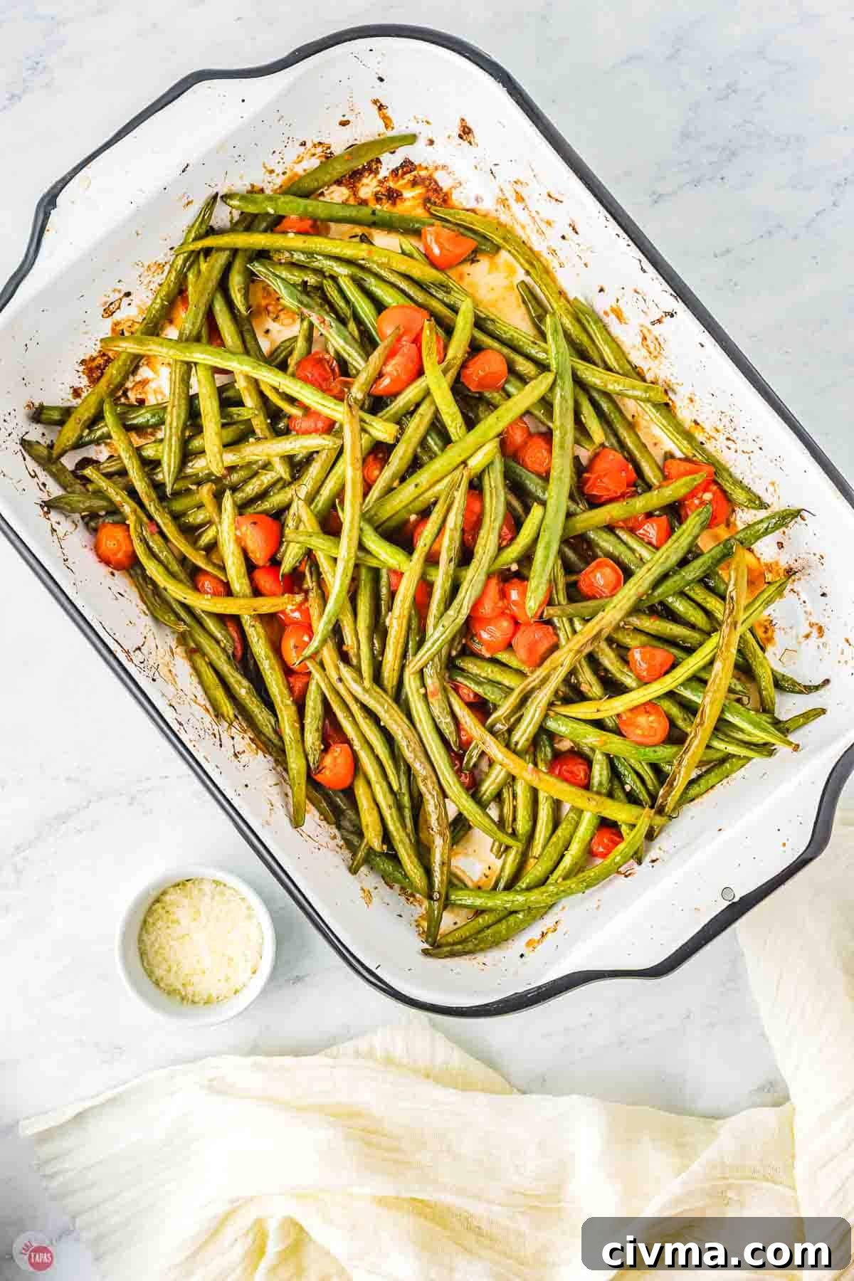 roasted Italian green beans and tomatoes in a white dish