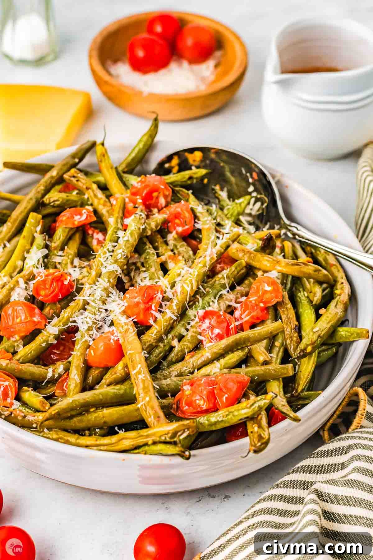 side view of bowl of Italian green beans with a silver spoon in them