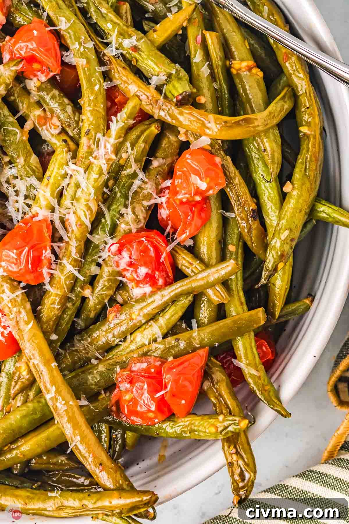 close up of green beans with shredded cheese on top