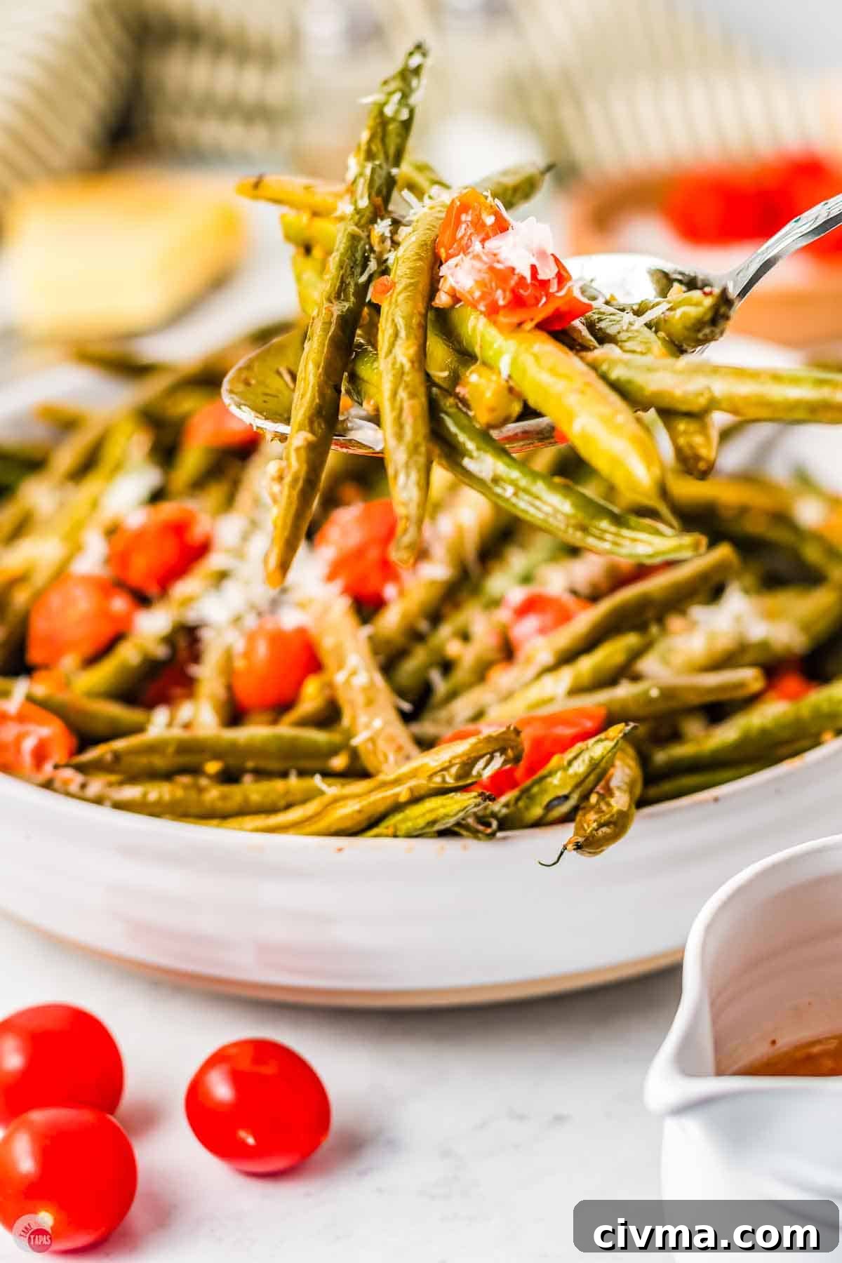 close up of fork with green beans speared on the end
