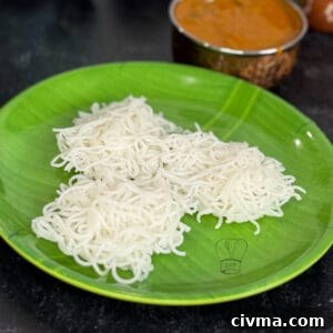 Idiyappam rice noodles served on a vibrant green plate, ready for a traditional South Indian meal.