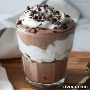 Cottage cheese chocolate mousse layered with whipped cream in a glass.