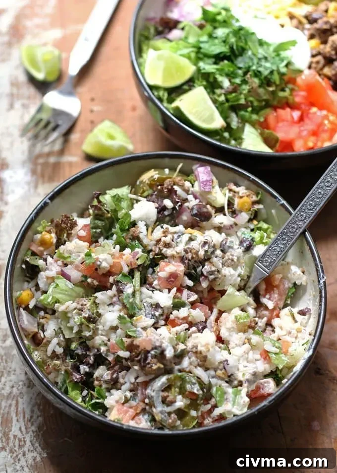 Several prepared burrito bowls on a counter