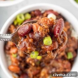 30 Minute BBQ Beef and Beans Recipe 7 Spoonful of beef and beans garnished with green onion.