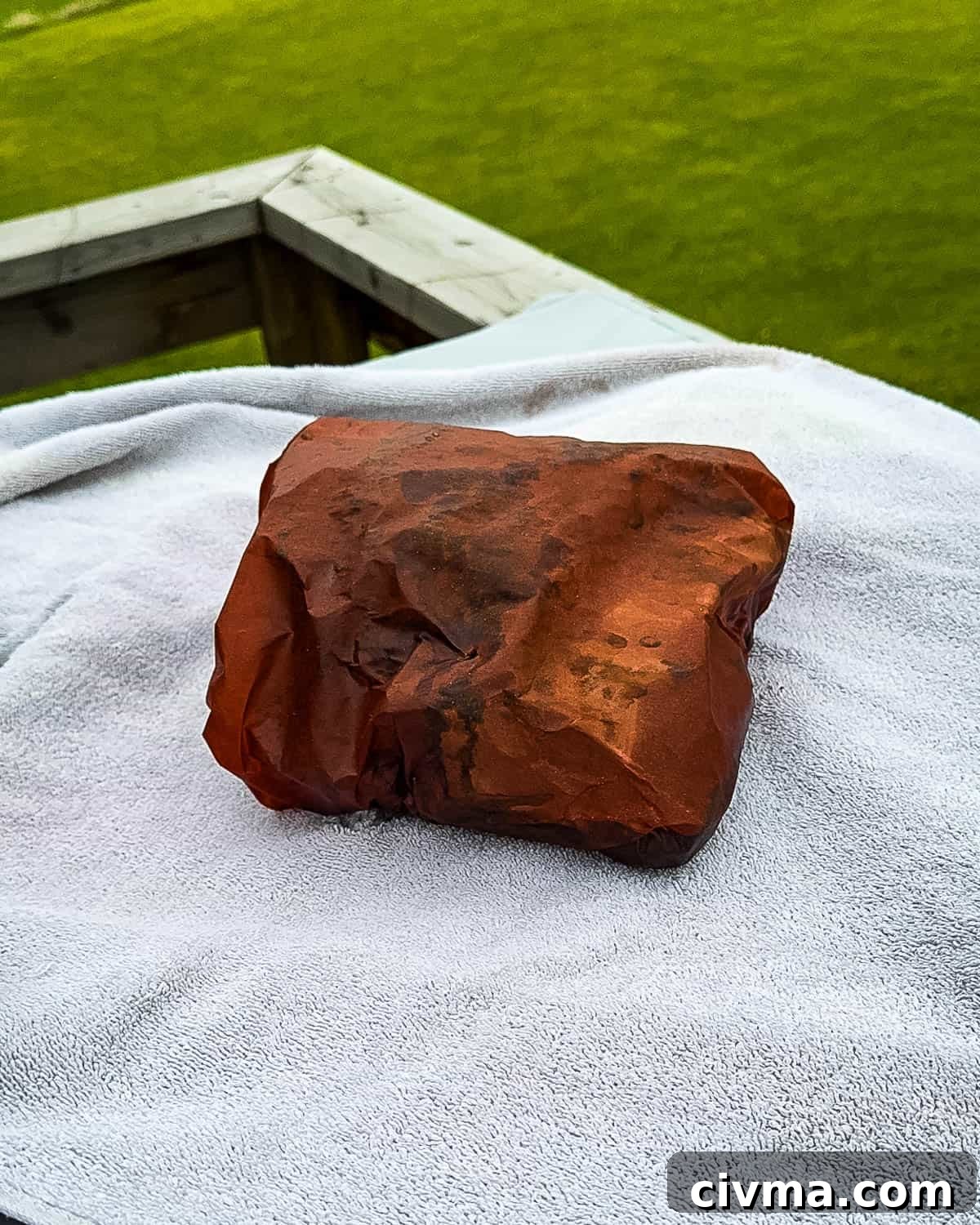The wrapped pork on a white towel.