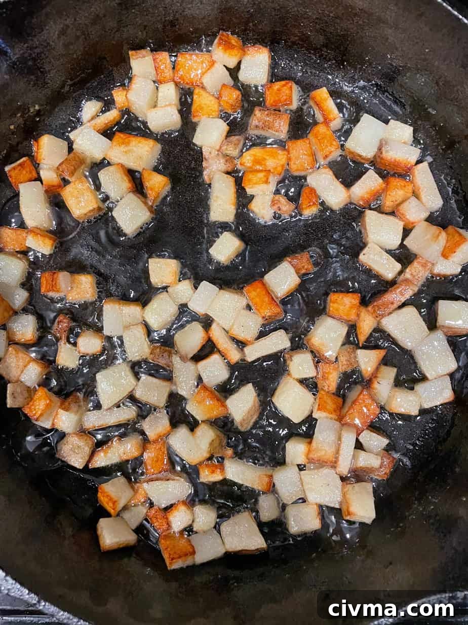 Potatoes cooking in a skillet.