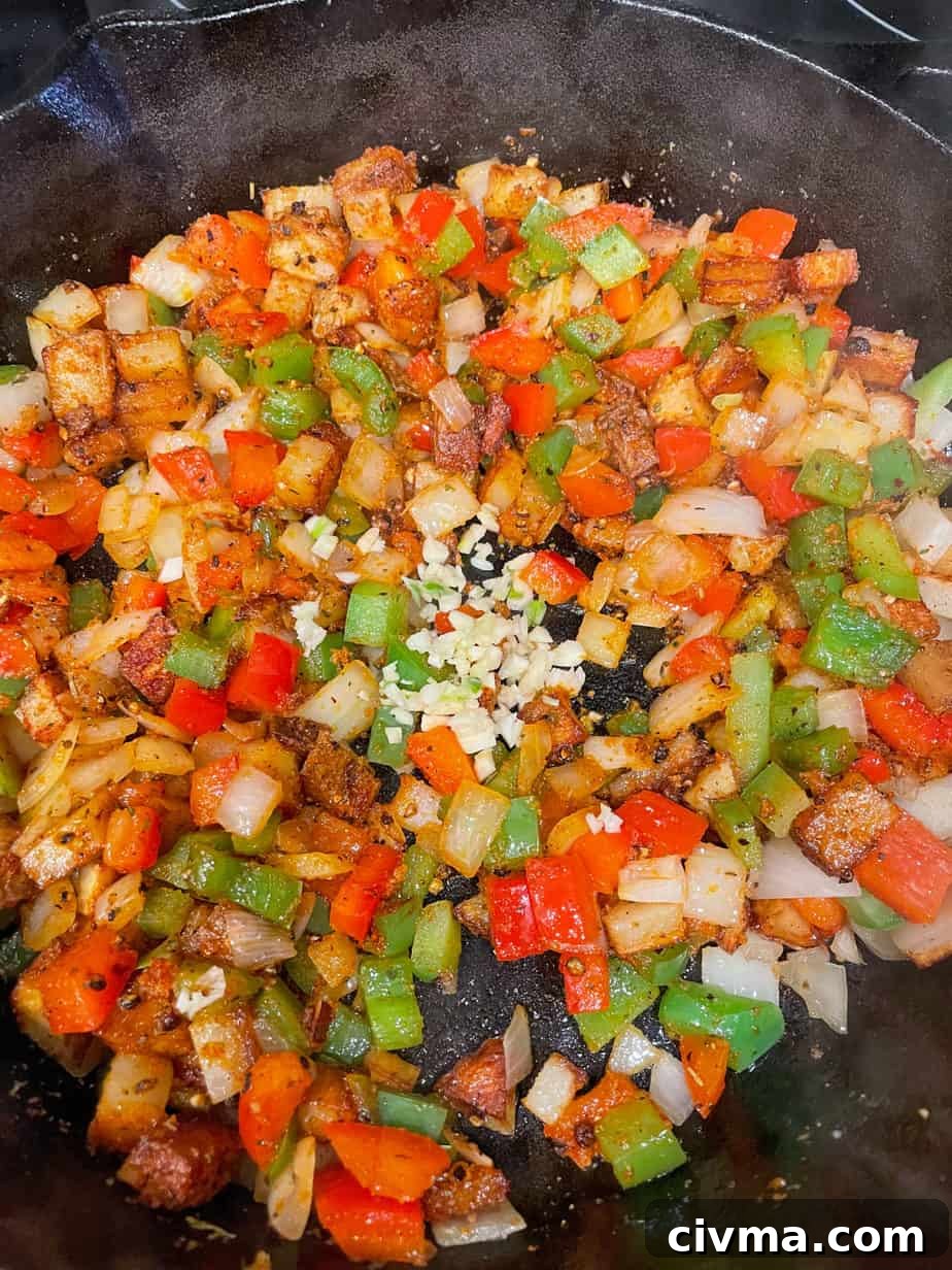 Bell peppers and onions added to the skillet.
