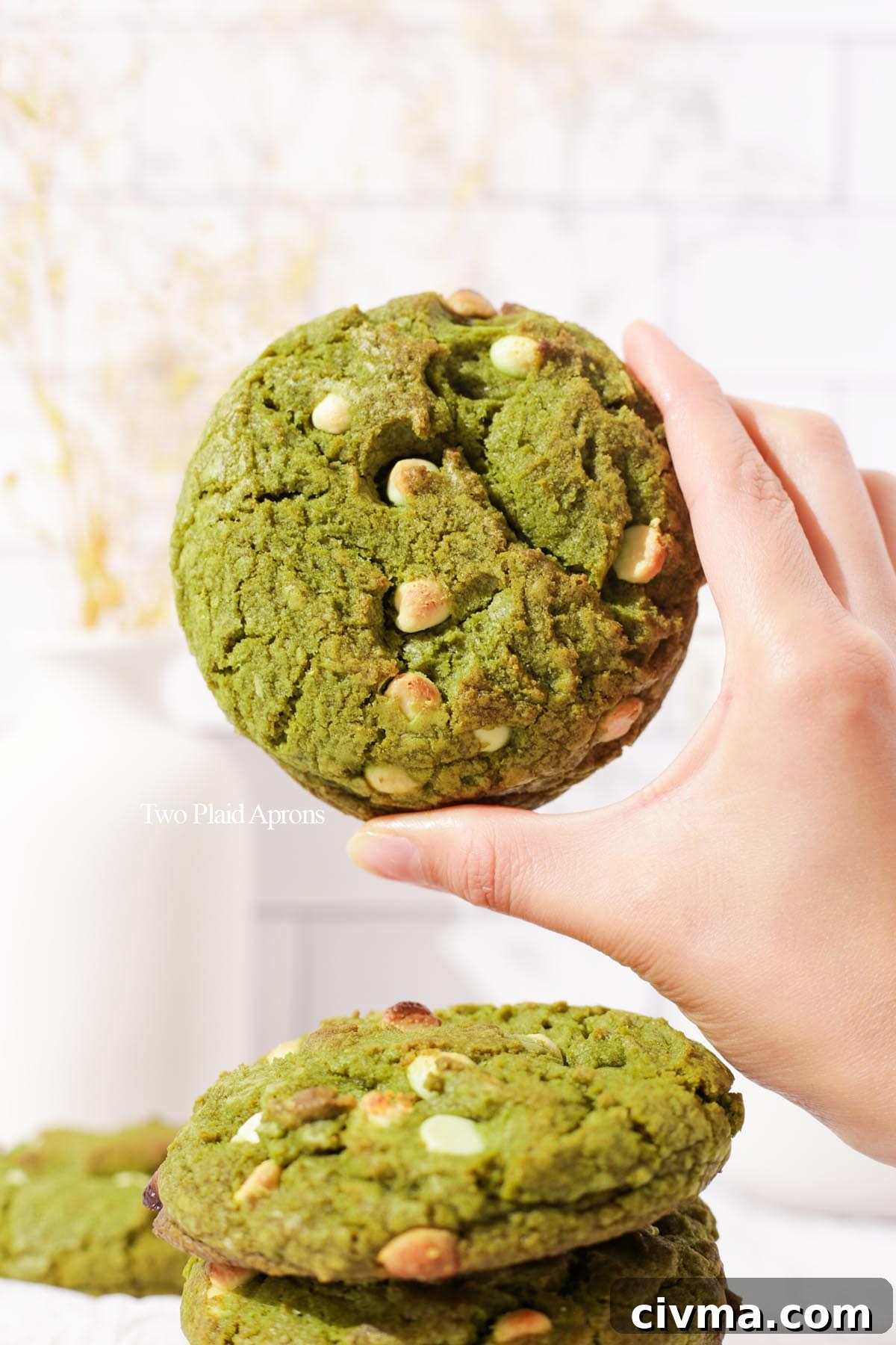 Soft Matcha White Chocolate Chip Cookies Recipe 2 Holding the matcha white chocolate cookie.
