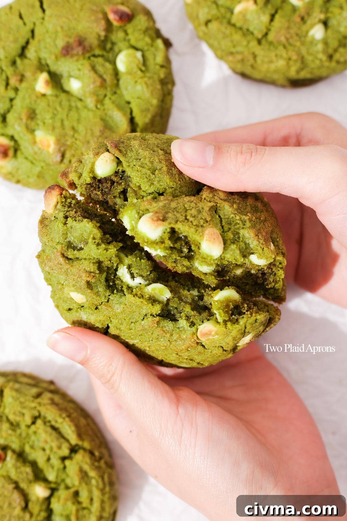 Soft Matcha White Chocolate Chip Cookies Recipe 3 Breaking the matcha white chocolate cookie in half.