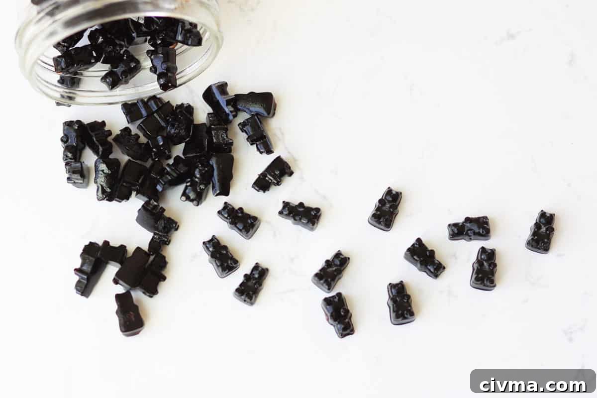 a jar of elderberry gummies spilled out on a counter