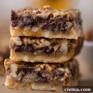 3 chocolate pecan pie bars stacked on top of each other
