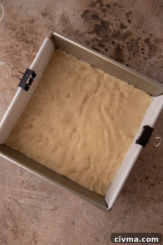 raw shortbread dough pressed into a baking dish