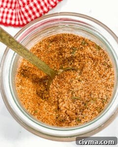 A jar filled with a blend of various ground spices labeled as burger seasoning.