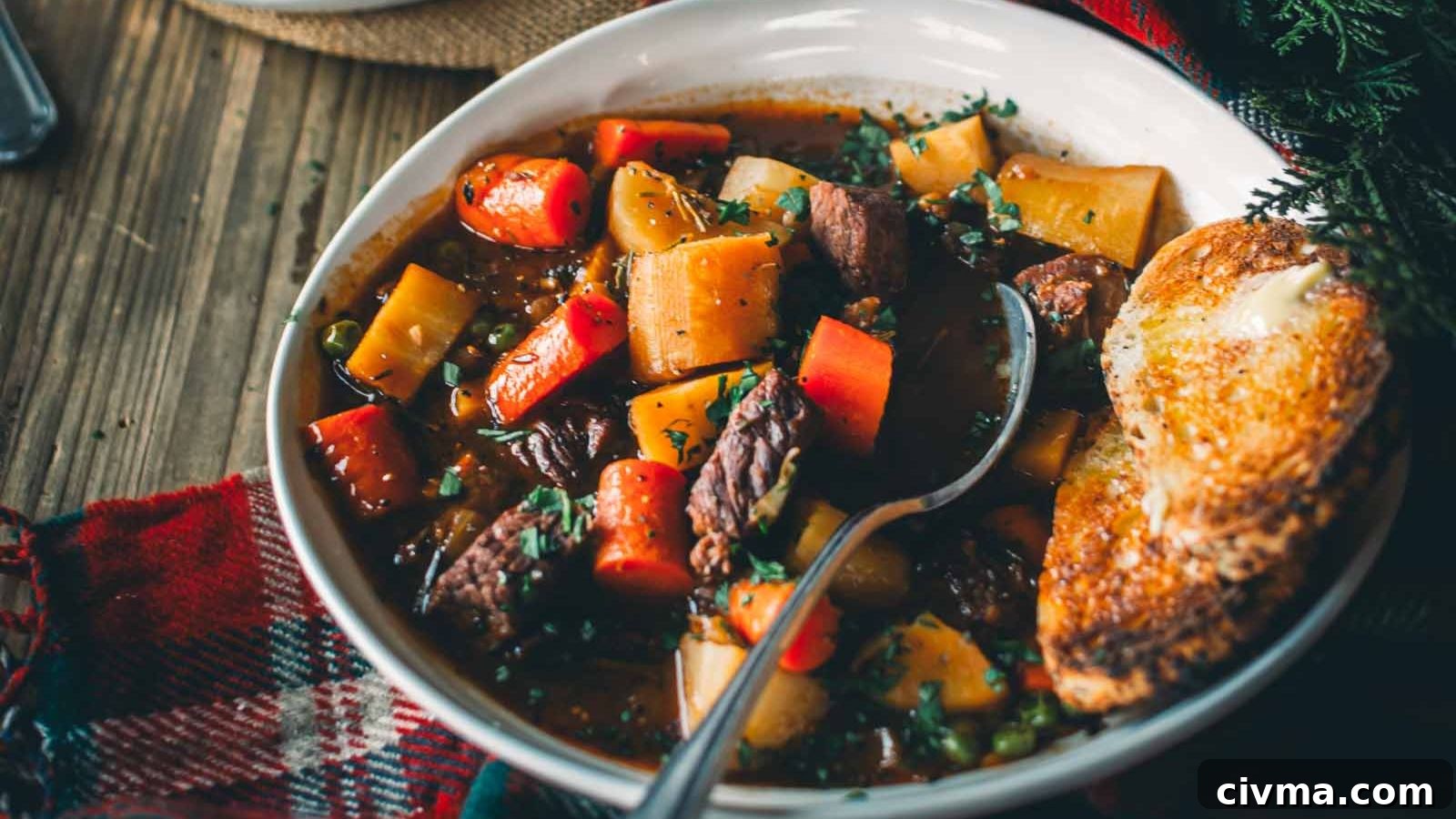 Guinness beef stew with deep rich broth and chunks of beef and vegetables.