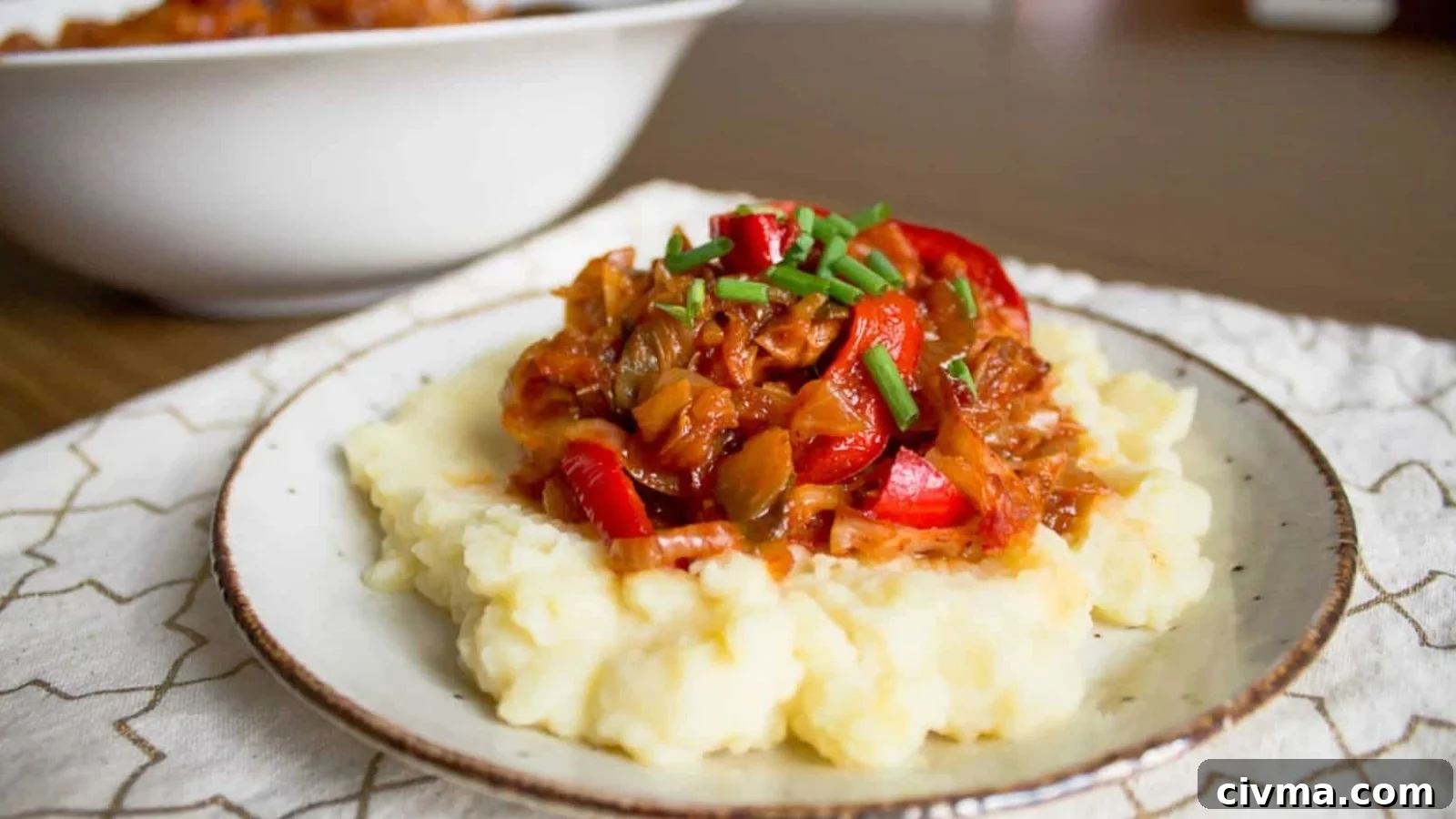 A plate with mashed potatoes and meat on it.