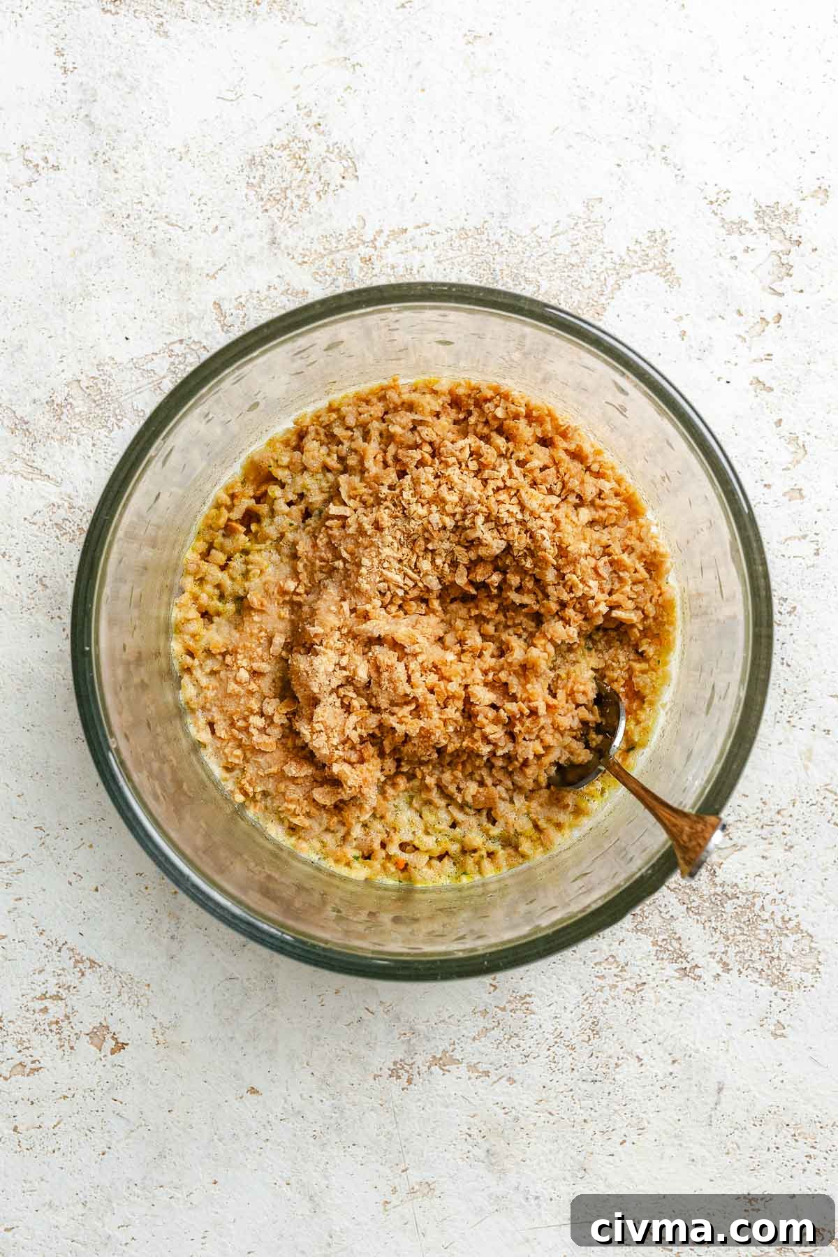 Process shot showing mixing ingredients in a bowl.