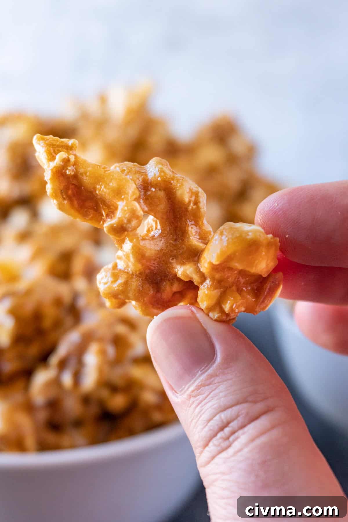 Homemade Caramel Popcorn Recipe 3 close up of caramel popcorn being held