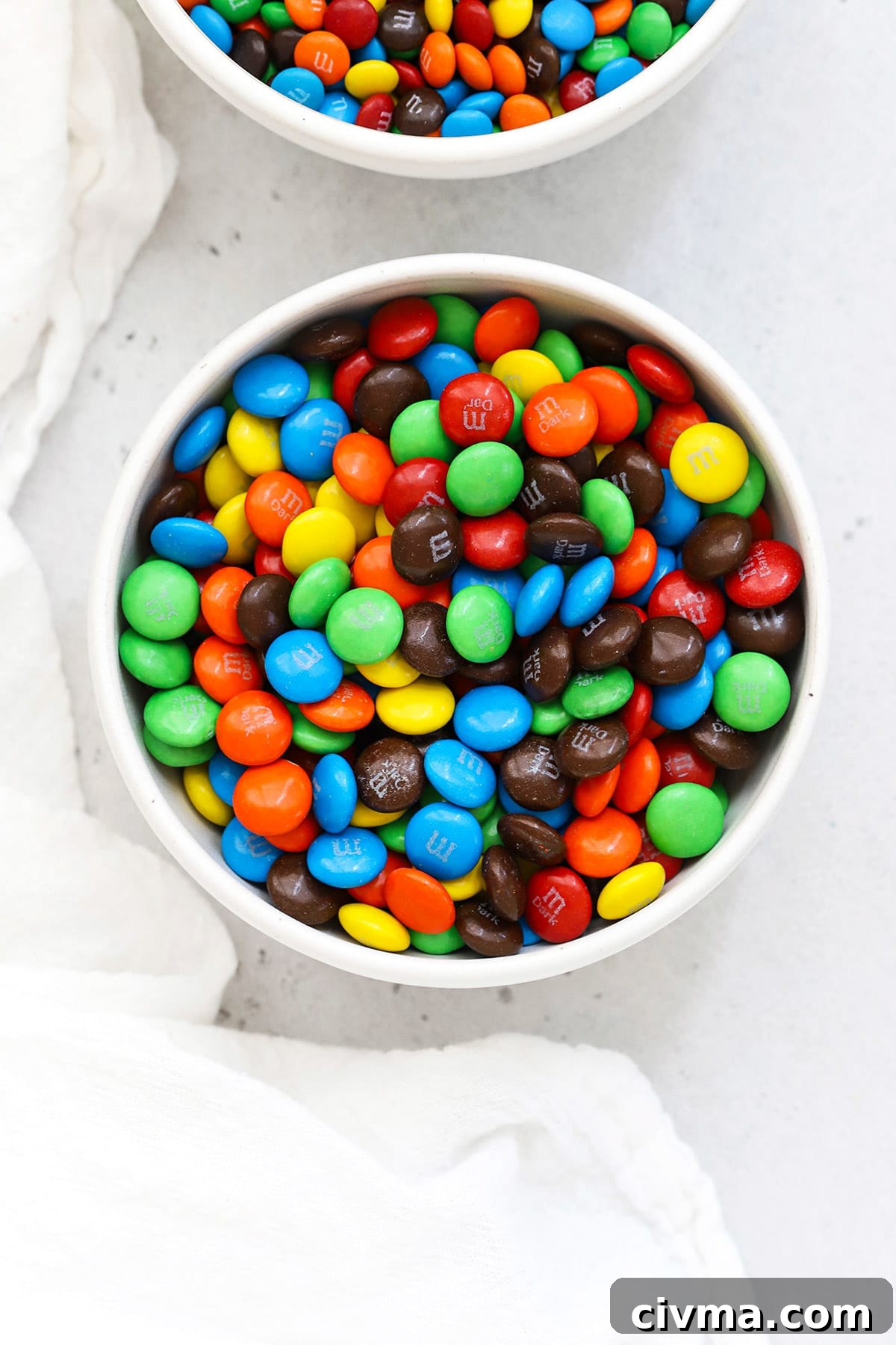 Overhead bowl of colorful M&Ms in a white bowl