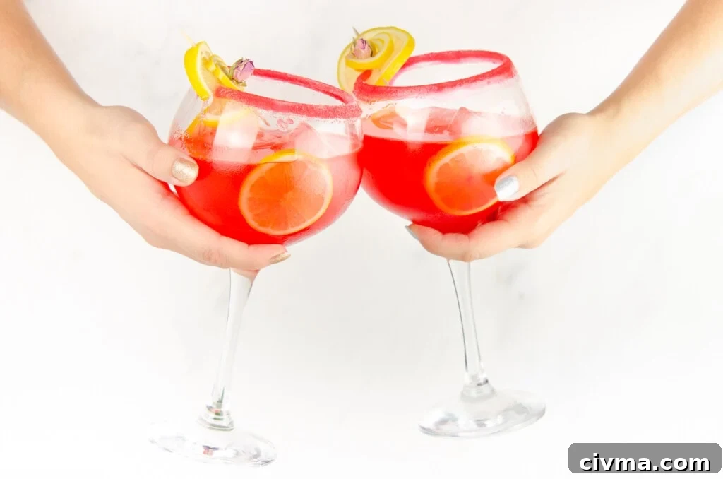 clinking glasses of our gin cocktail to say cheers