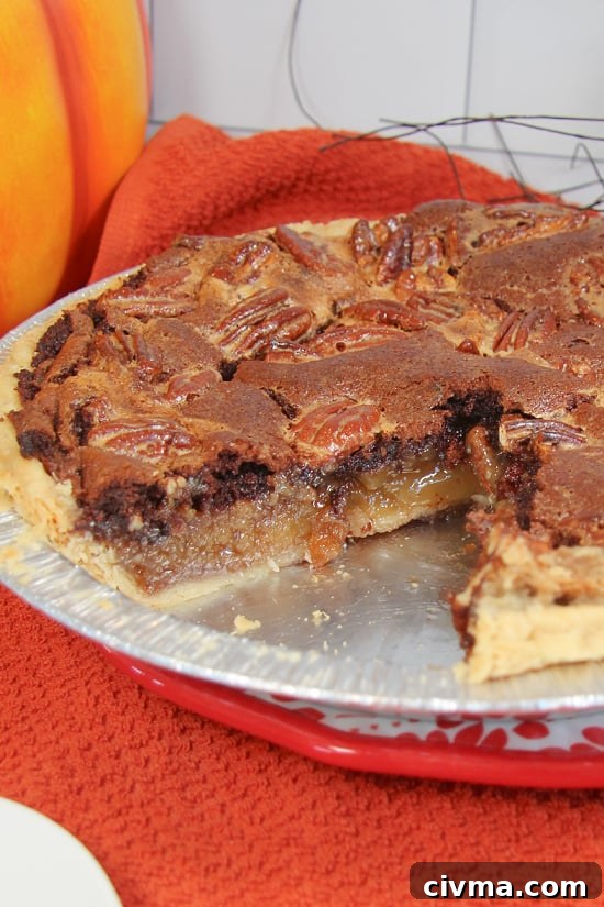 Black Bottom Pecan Pie is a rich and decadent treat that is so satisfying. The inside cut of a chocolate and pecan dessert.