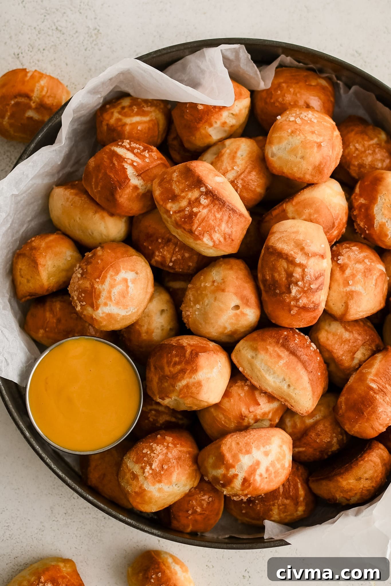 Homemade Soft Pretzel Bites Recipe 2 Dozens of soft pretzel bites topped with coarse sea salt and served with a side of beer cheese served in a large aluminum serving tray.
