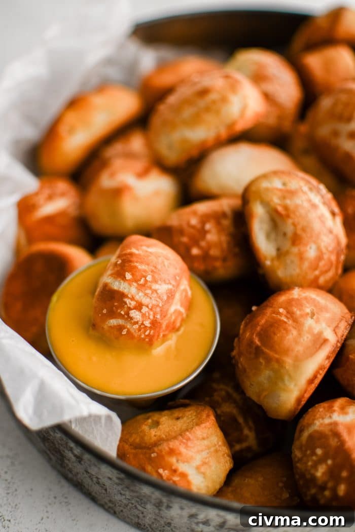 Homemade Soft Pretzel Bites Recipe 5 Dozens of soft pretzel bites topped with coarse sea salt and served with a side of beer cheese served in a large aluminum serving tray.