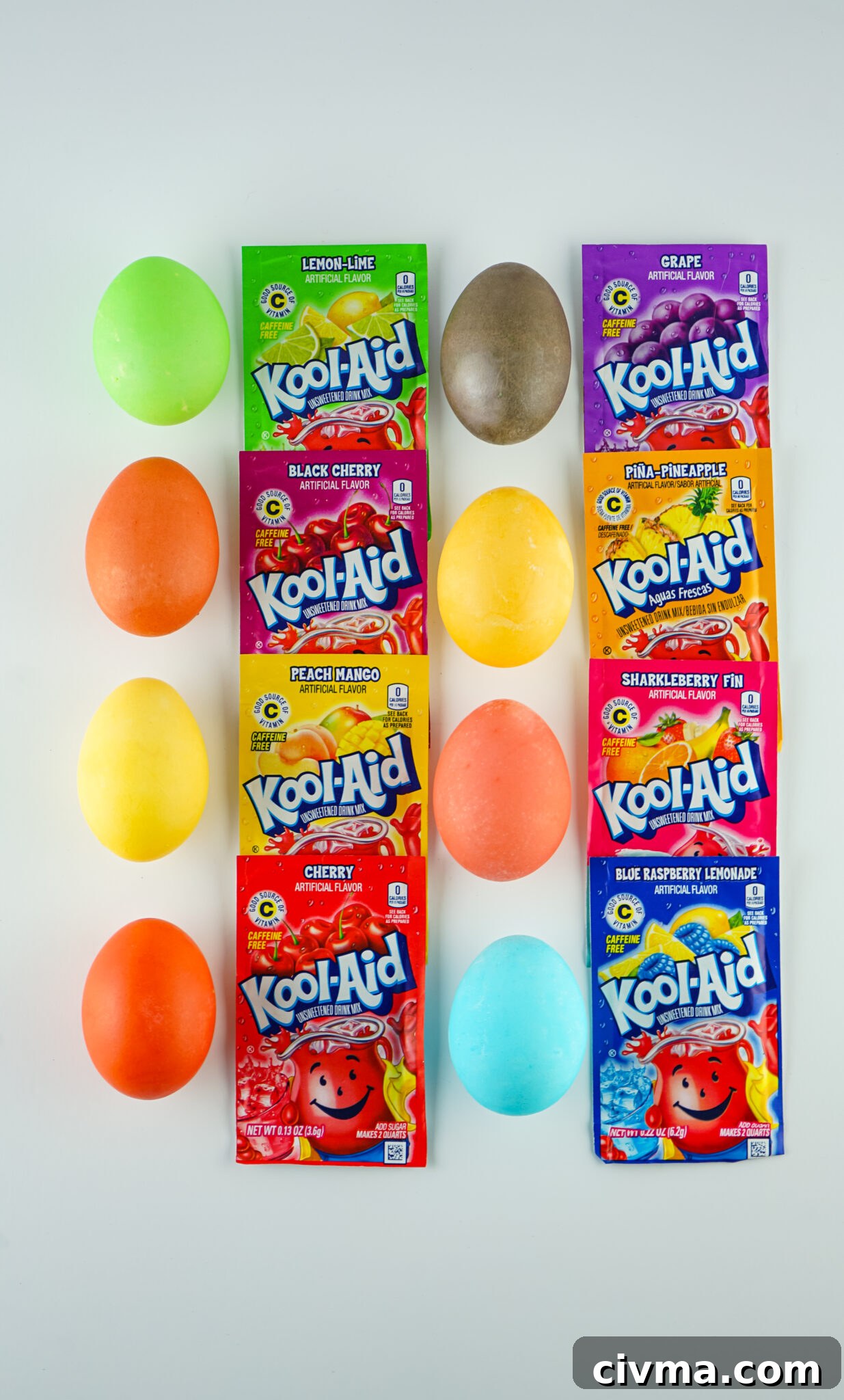 bright colored kool-aid dyed eggs with packets of kool-aid next to each colored egg