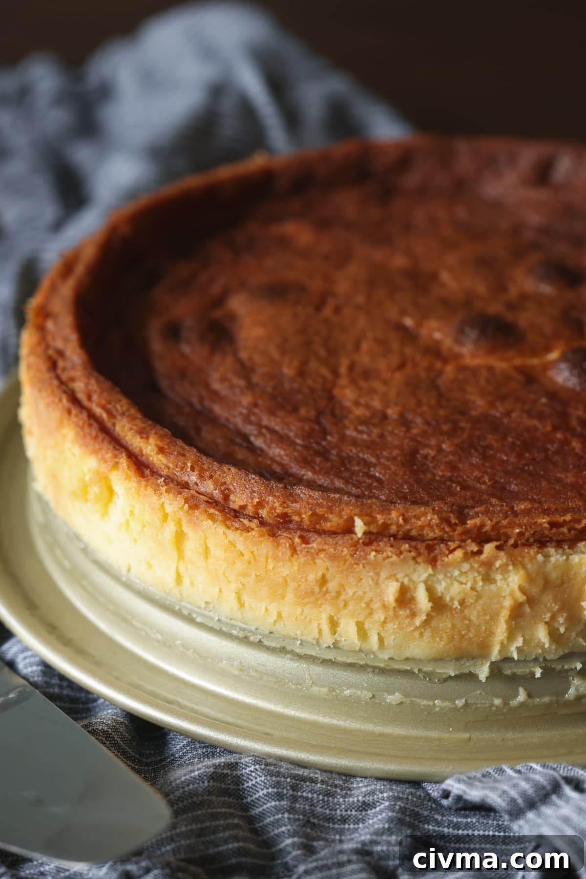 Baked flourless white chocolate cake on a plate.