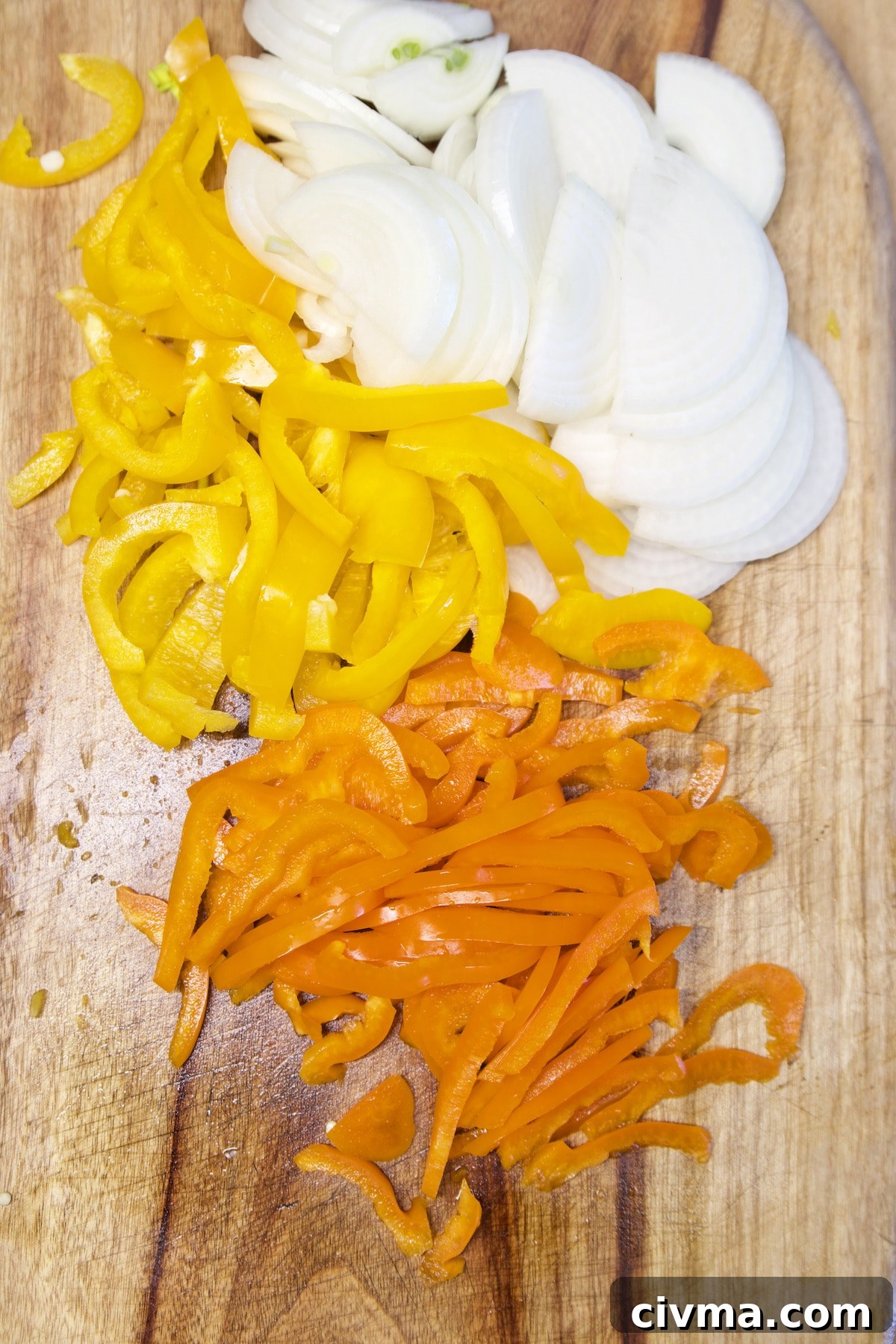 Cheesesteak Sliders. Sliced onions, yellow and orange bell peppers.