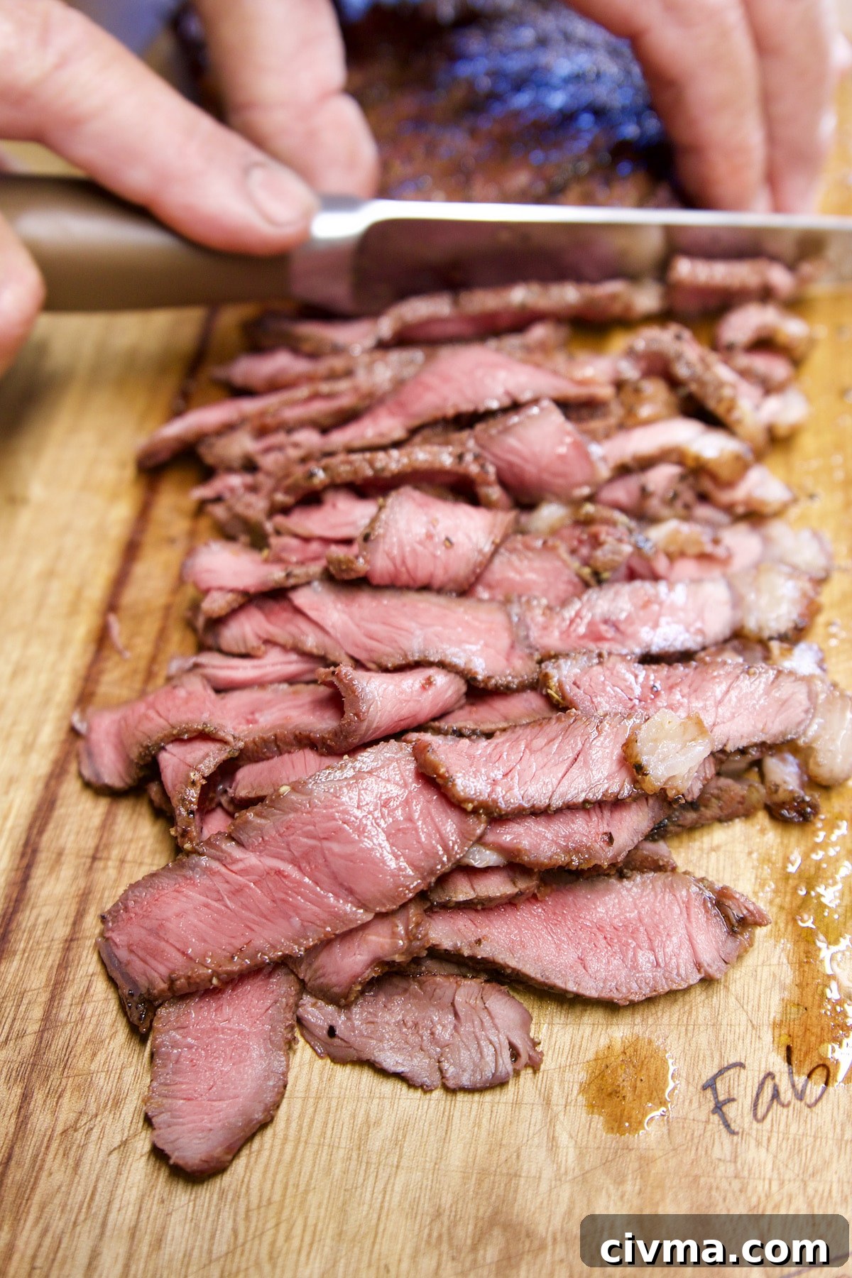Cheesesteak Sliders with grilled sirloin steak. Slicing sirloin steak.