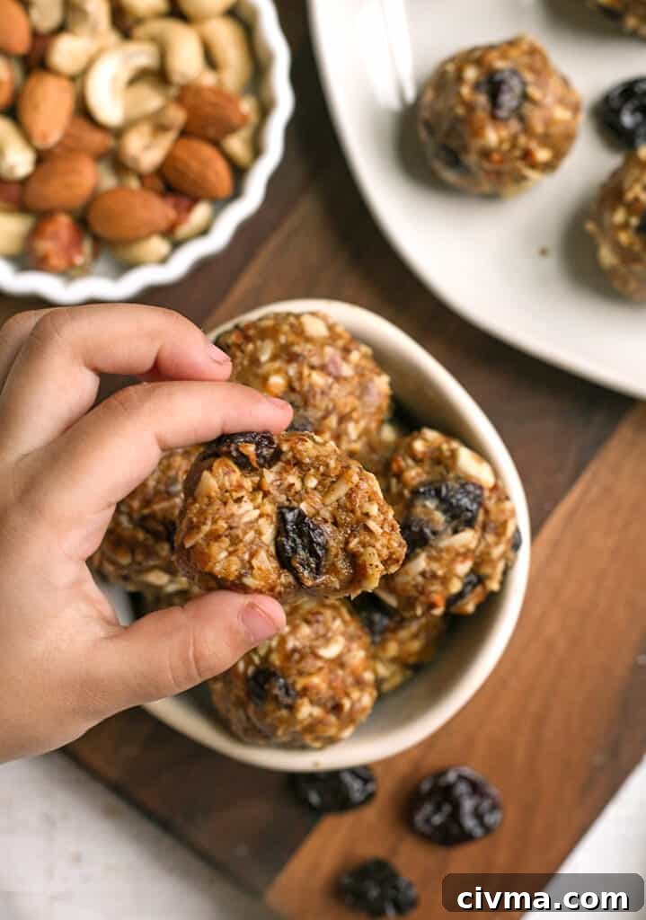 tart cherry granola bites, hand taking one