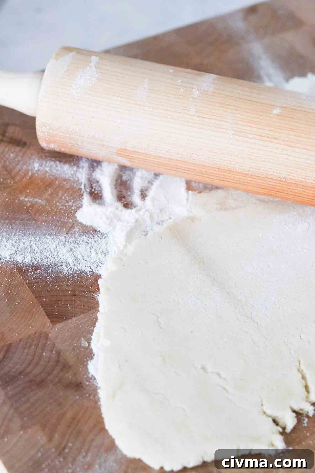 Gluten free dough rolled out on a cutting board.