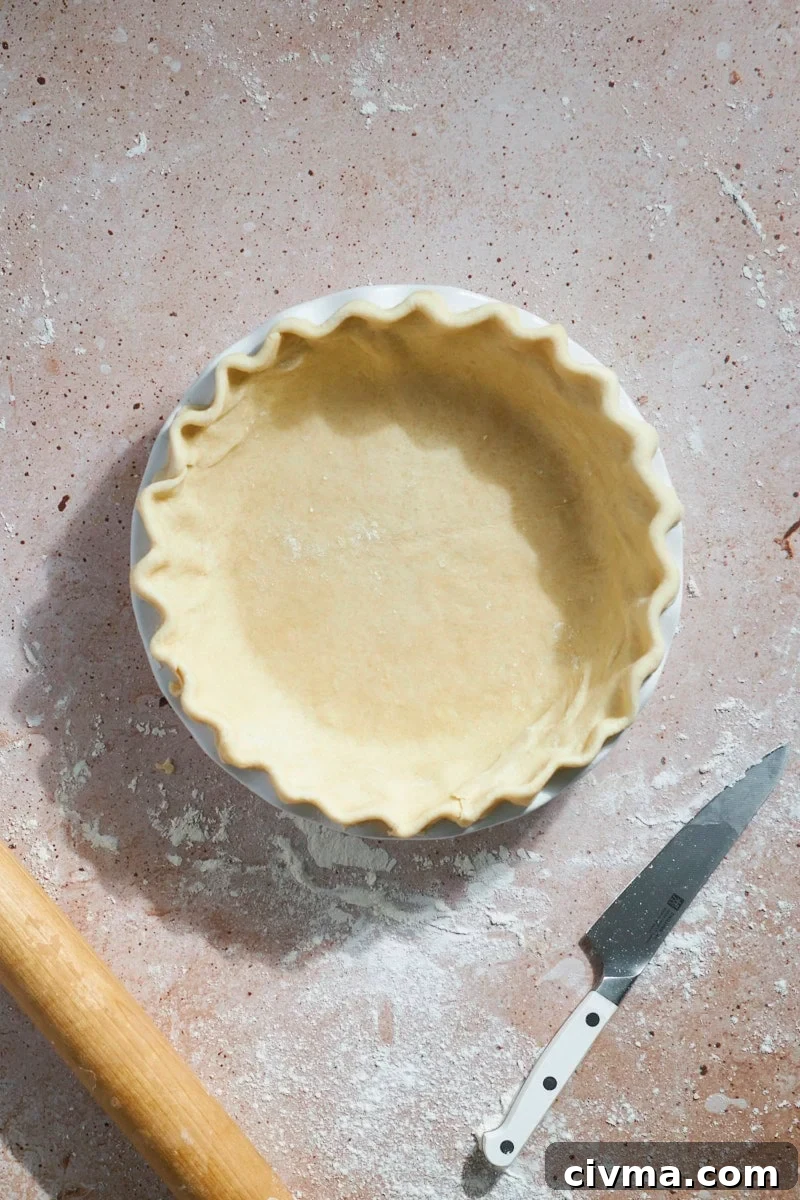 Pie crust shaped and crimped in a pie pan.