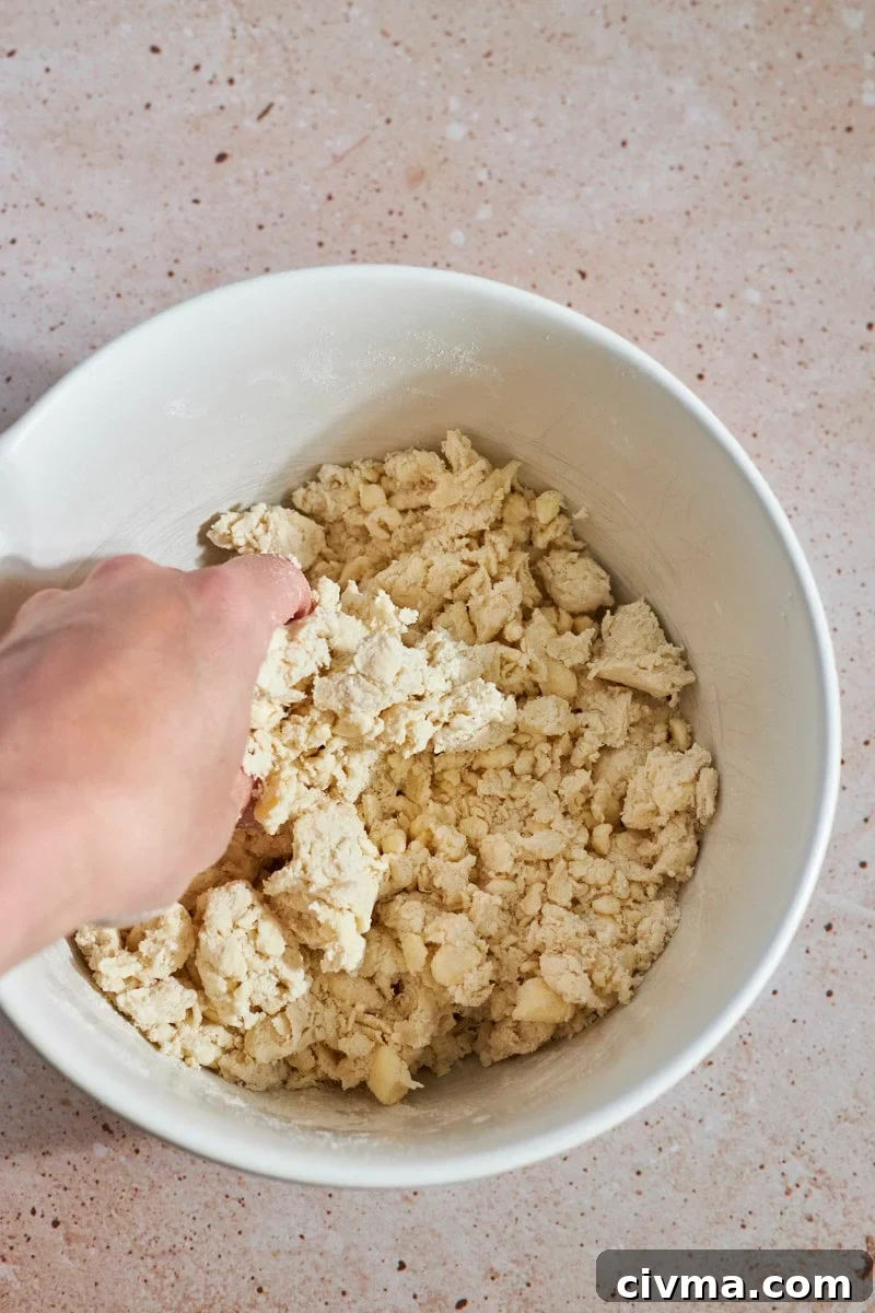 Shaggy, coarse dough mixed in a large bowl.