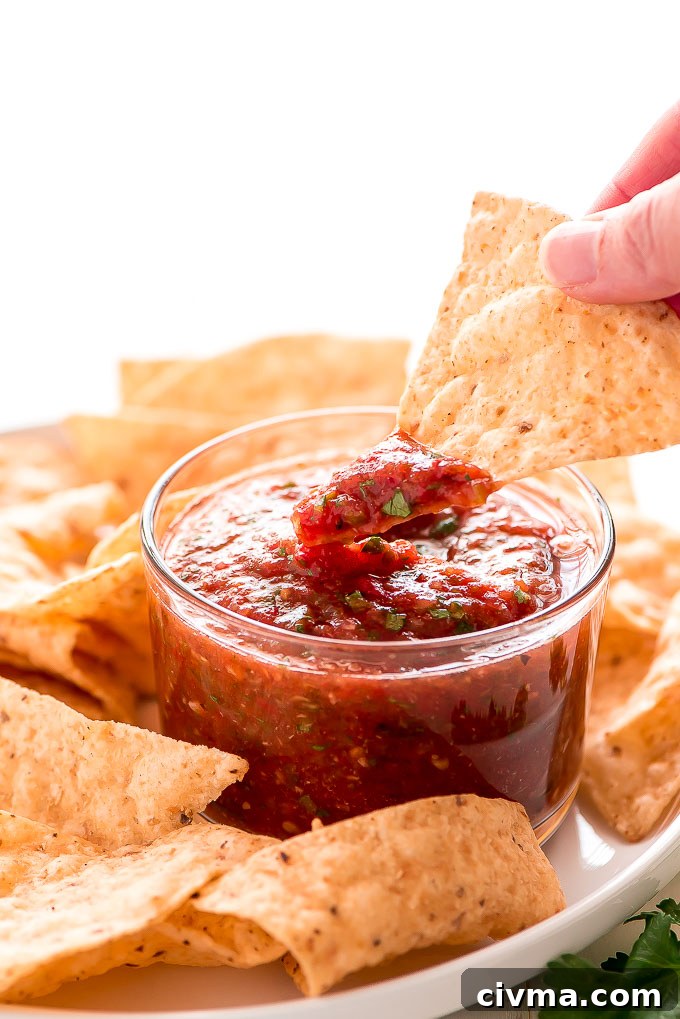 Homemade roasted tomato salsa made with fresh vegetables, cilantro, lime juice, salt, and cumin.