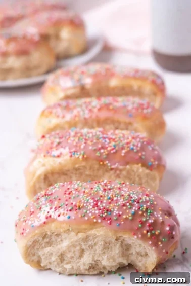 Sourdough discard iced buns lined up on a counter